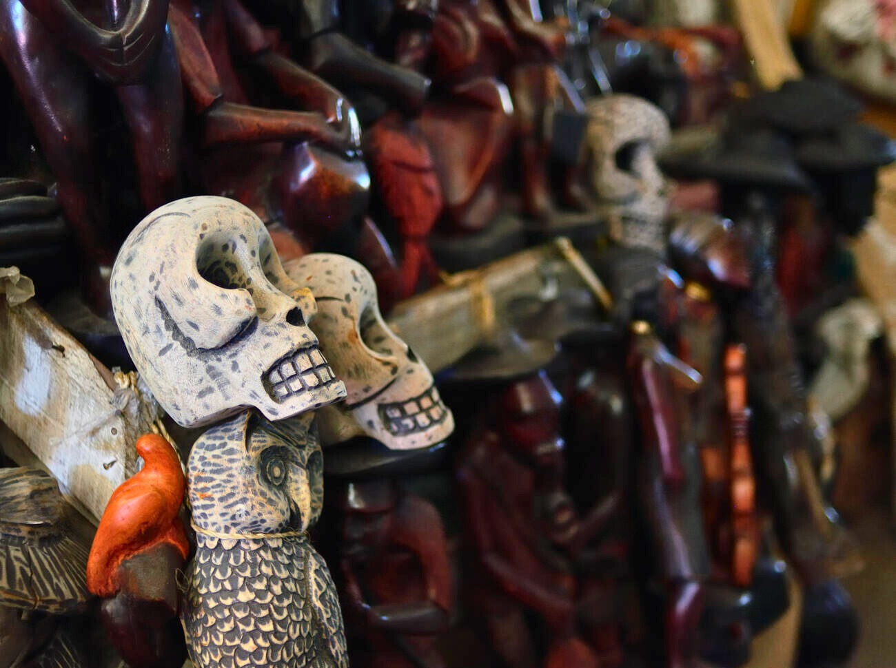 Carved skulls and owls representing Voodoo culture artifacts in Haiti.