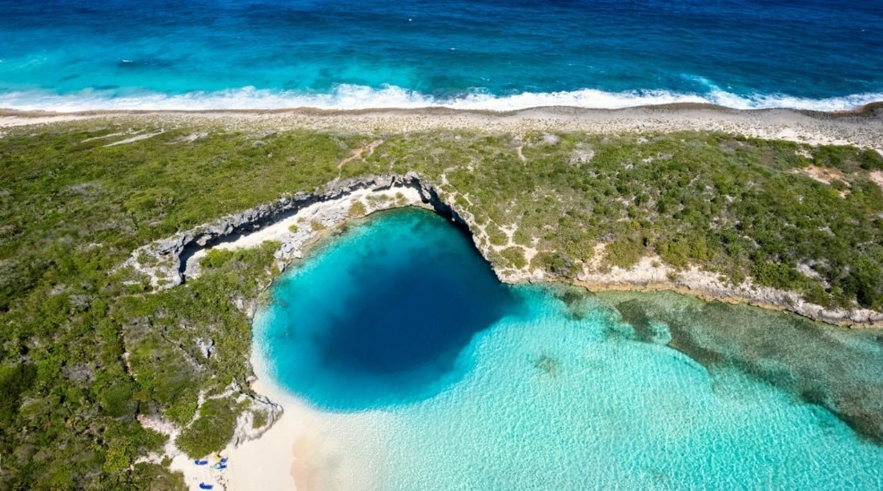 Aerial view of the Dean’s Blue Hole marine blue hole, ringed by white sand, on Long Island in the Bahamas