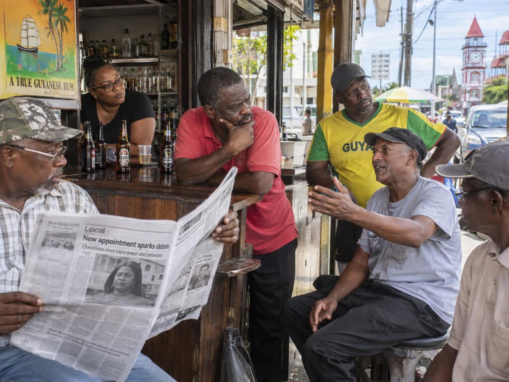 Monkey turn captain: neighborhood bar scene in Guyana, residents discussing a surprising appointment