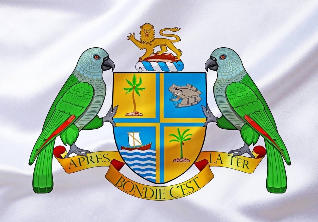 Coat of arms of Dominica with the motto Après Bondie c’est la terre on its scroll, held by two sisserou parrots