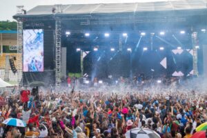Crowd cheering in front of the main stage at Windsor Park Stadium in Roseau during the World Creole Music Festival